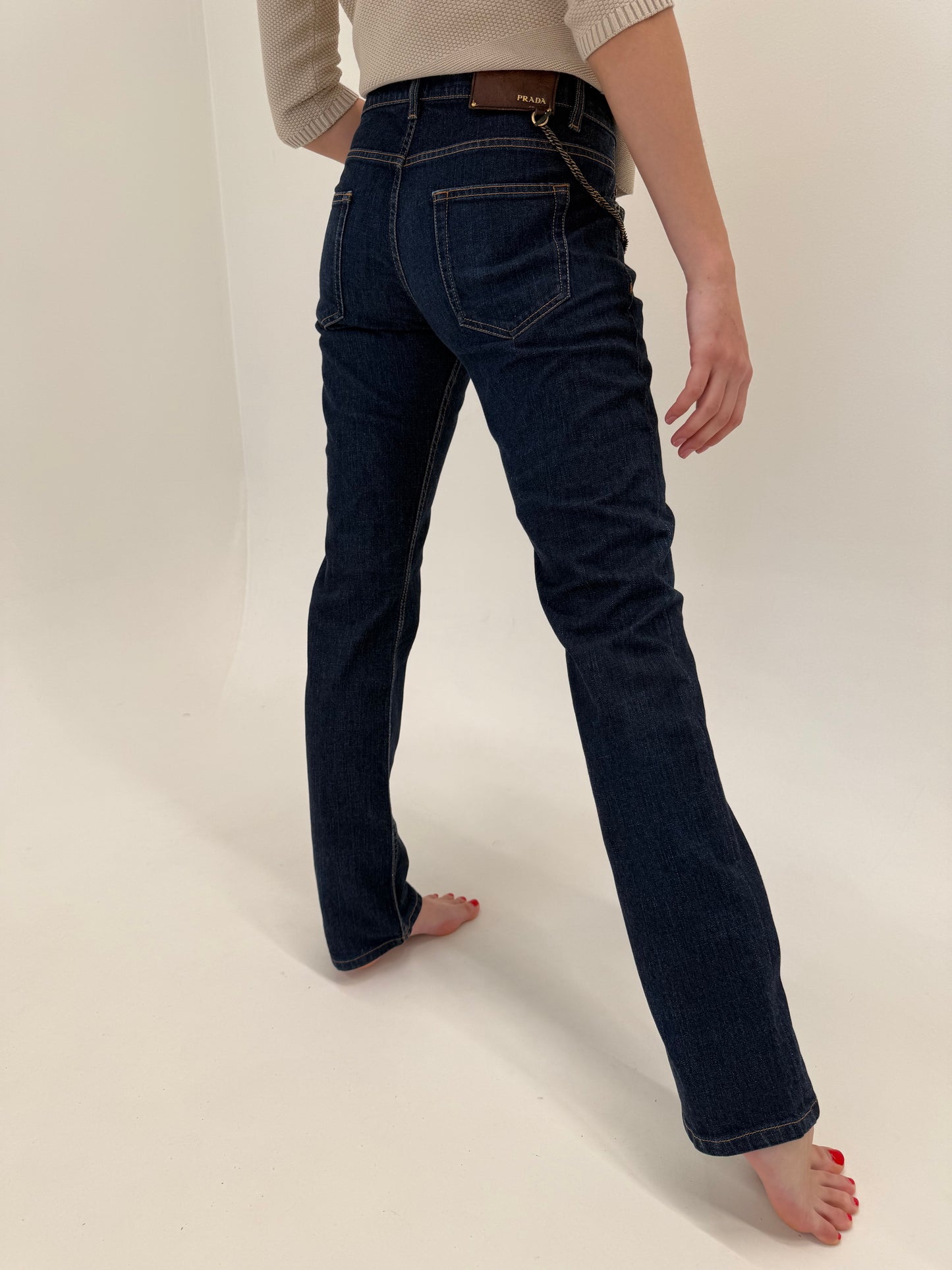 Jeans tall Prada dark wash cu decorațiune metalică detașabilă
