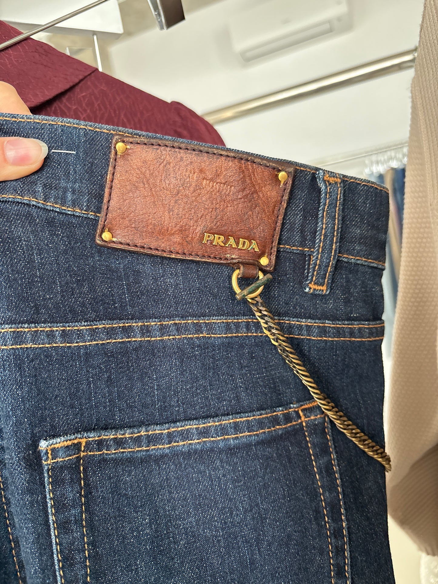 Jeans tall Prada dark wash cu decorațiune metalică detașabilă